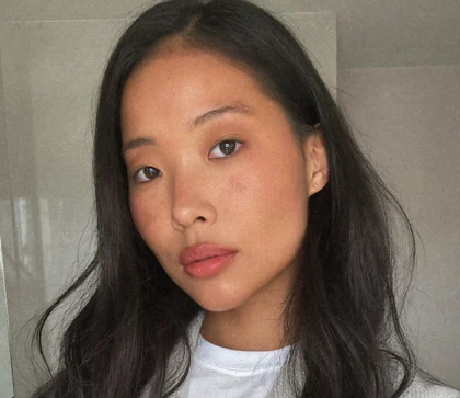 The creator we made: a woman in her mid-twenties in a bathroom, ready to show the product.